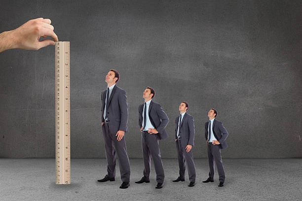 istock Composite image of hand measuring businessmen with ruler 497078621