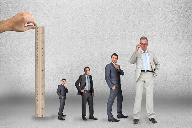 istock Composite image of hand measuring businessmen with ruler 497078633