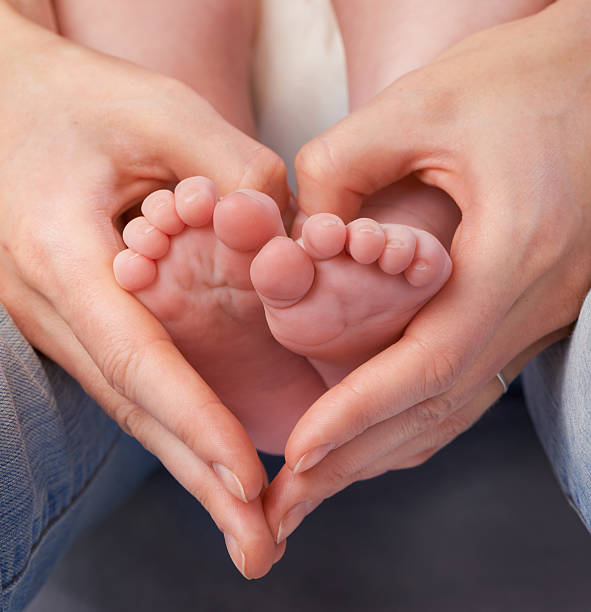 Loving the little things Cropped shot of a mother&#039;s hands making a heart shape around her baby&#039;s feethttp://195.154.178.81/DATA/i_collage/pi/shoots/783360.jpg unknown gender stock pictures, royalty-free photos & images