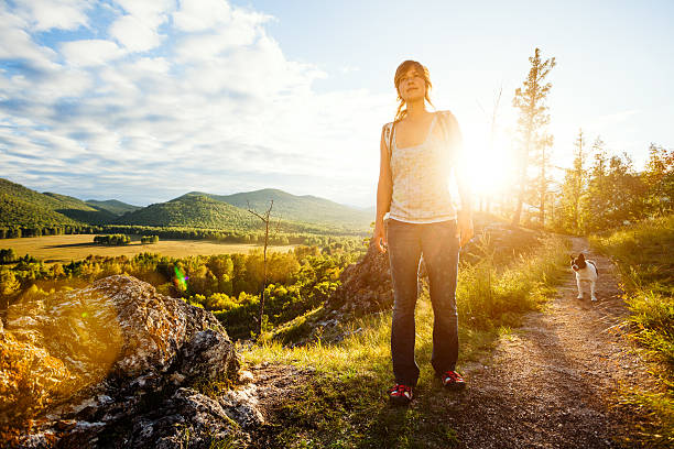 young beautiful woman trekking  in  mountains. Some lens flare