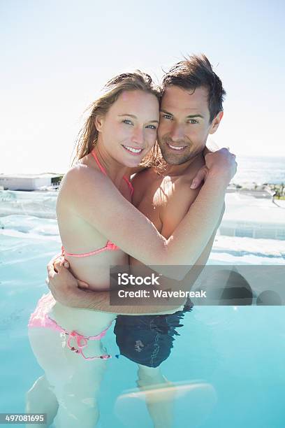 Loving Young Couple Embracing In Swimming Pool Stock Photo - Download Image Now - 20-29 Years, 30-39 Years, Adult