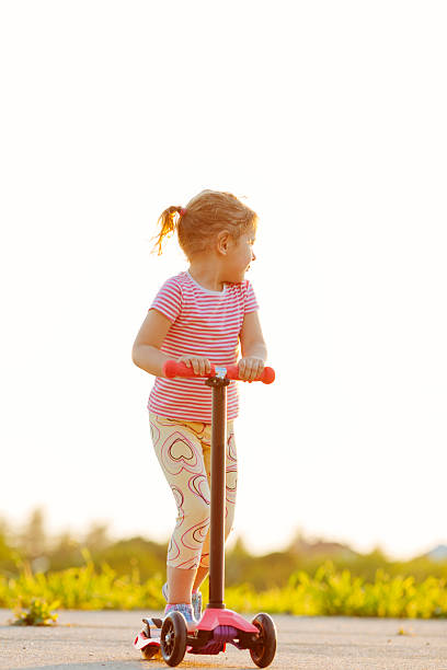 istock Little girl riding push scooter. 497082719