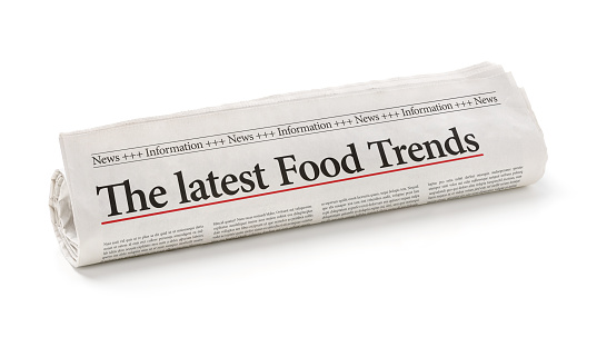 Rolled newspaper with the headline The latest Food Trends