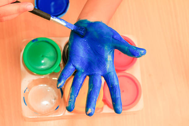istock childrent painting color on her hand 497089878