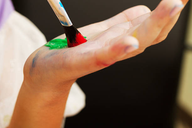 istock childrent painting color on her hand 497090362