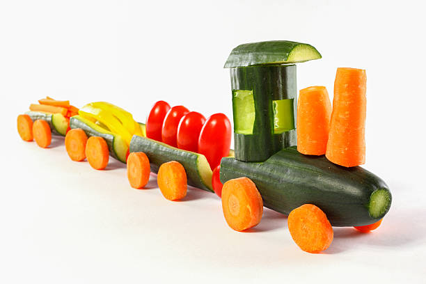 Cucumber train - From cucumbers and other vegetables carved train Cucumber train - From cucumbers and other vegetables carved train carving fruit stock pictures, royalty-free photos & images