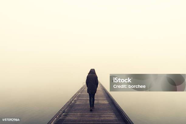 Woman Crossing The Bridge Stock Photo - Download Image Now - Fog, Women, One Woman Only