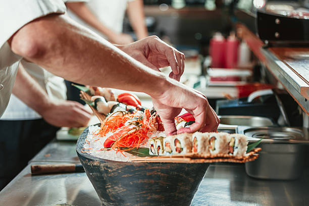 male cooks preparing sushi