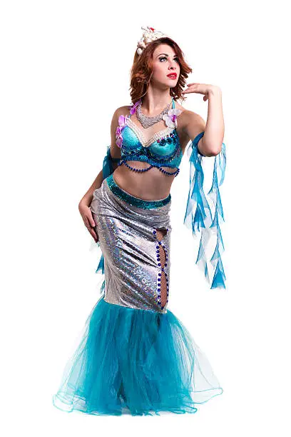 Carnival dancer woman dressed as a mermaid posing, isolated on white background in full length.