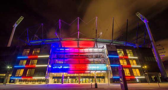 Melbourne, Australia - November 14, 2015: The National Sports Museum entrance to the Melbourne Cricket Ground (MCG), lit up in red, white and blue in solidarity with France following the Paris terror attacks.