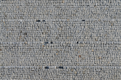 Cobbled pavement pattern made of granite cubes.