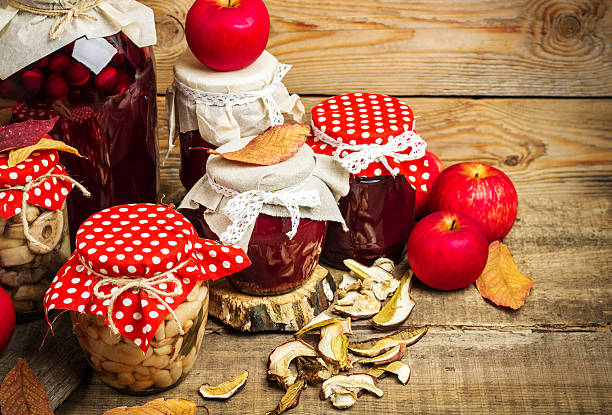 Still life, food and drink, seasonal concept. Autumn preserved fruits, vegetables and mushrooms on a rustic wooden table. Selective focus, copy space
