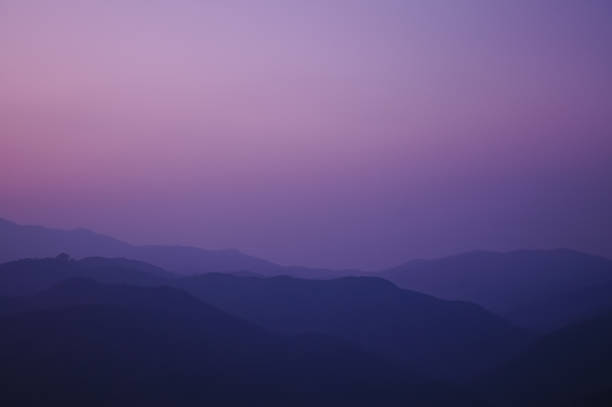 istock twilight sunset at the peak of the mountain 497103079