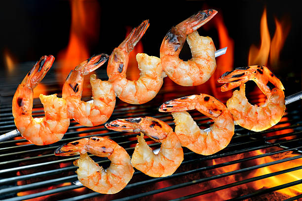 Grilled shrimps Grilled shrimps on the flaming grill. prawn grilled seafood prepared shrimp stock pictures, royalty-free photos & images