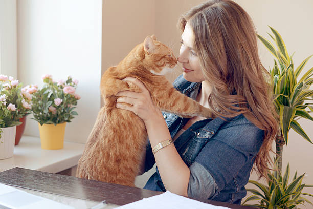 istock beautiful woman and ginger cat 497103616