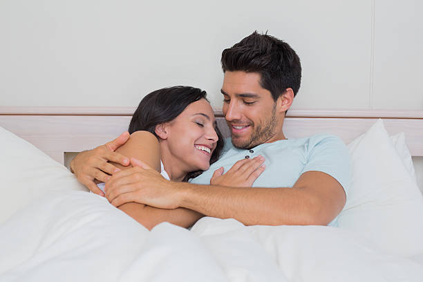 istock Attractive couple cuddling in bed 497110113
