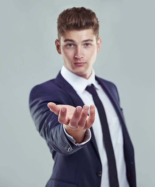 Welcome to the digital age Concept studio shot of a young businessman standing with his open palm raised to the camerahttp://195.154.178.81/DATA/i_collage/pi/shoots/783268.jpg men hands stock pictures, royalty-free photos & images