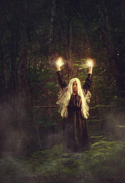 istock female sorcerer in the woods 497112889