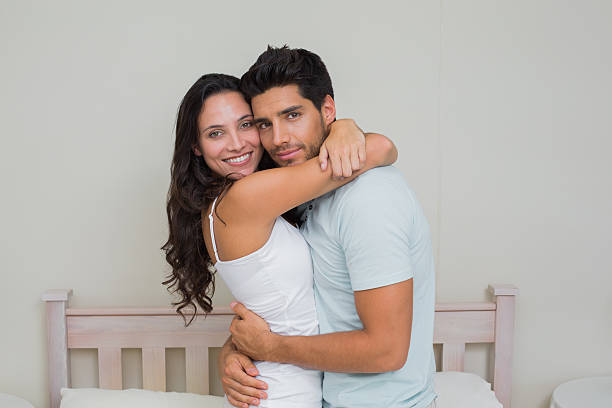 istock Cute couple hug while smiling to the camera 497112919