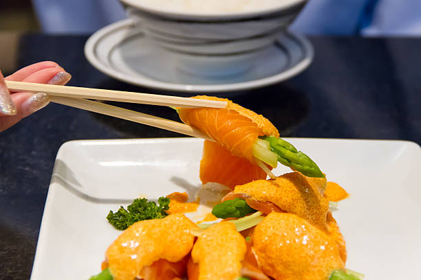 istock Chopstick with salmon roll and shrimp egg sauce 497113447