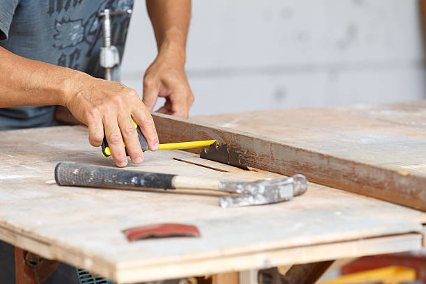 istock carpenter cut wood for house construction 497113651
