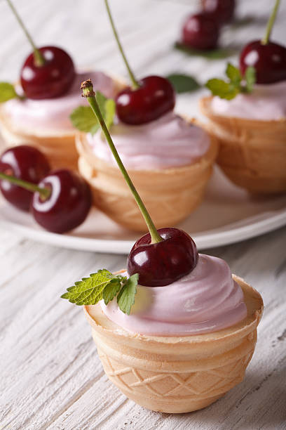 istock sweet tartlet with cream and cherry close up. vertical 497115990