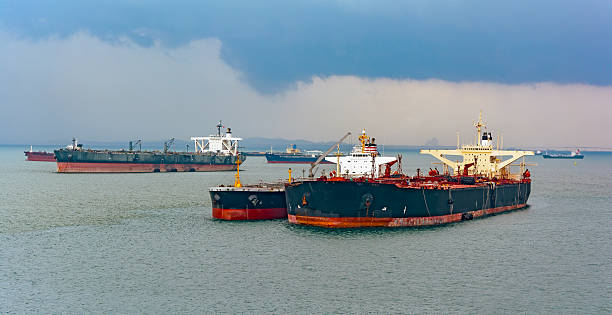 istock Loading anchored oil supertanker via a ship-to-ship oil transfer 497116292