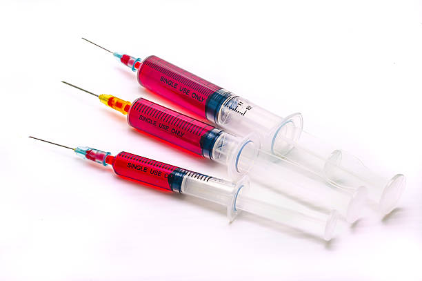 istock Syringe with blood isolated on white background 497116986