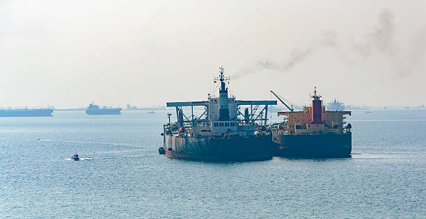 istock Loading anchored oil supertanker via a ship-to-ship oil transfer 497117128