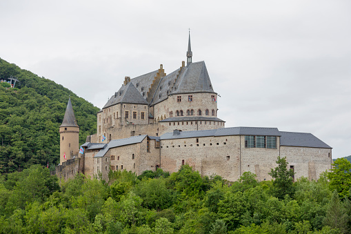 Vianden, Luxembourg - July 20, 2015:  Vianden Castle is located in the north of Luxembourg, near the border of Germany, nestled into and surrounded by trees.  It is a very large fortified castle in Europe, with its origins dating back to as late as the 10th century.  It is now a popular tourist attraction after falling into disrepair for a number of years. 
