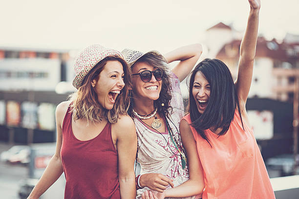 Young women smiling on roof of a building