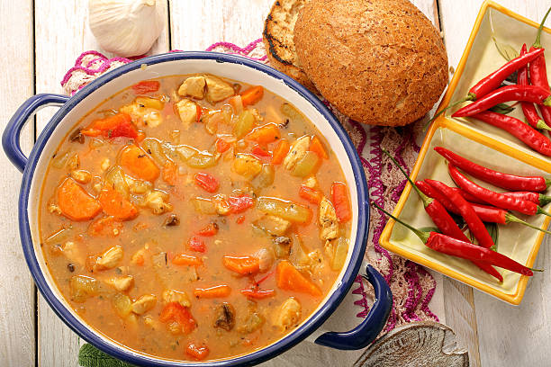 istock Chicken stew with hot chilli in metal pot 497121128