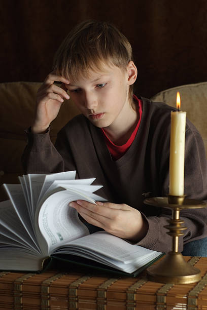 istock Happy Caucasian boy sitting at a table 497121602
