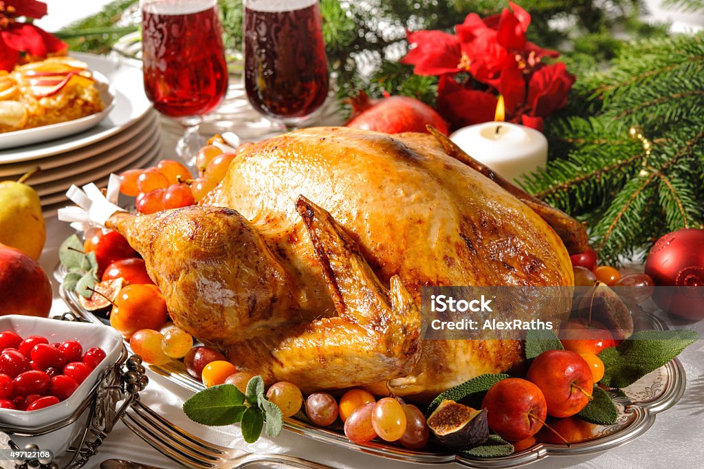 Roasted turkey on holiday table Roasted turkey on holiday table with candles 2015 Stock Photo