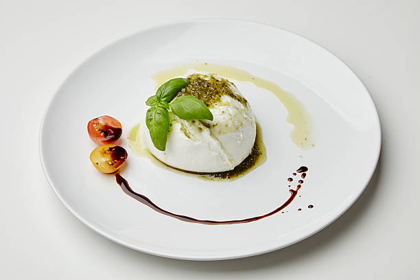 istock Mozarella served with pesto, cherry tomatoes and basil on white 497122550