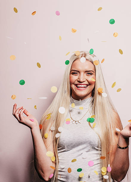 istock Beautiful woman throwing confetti 497122814