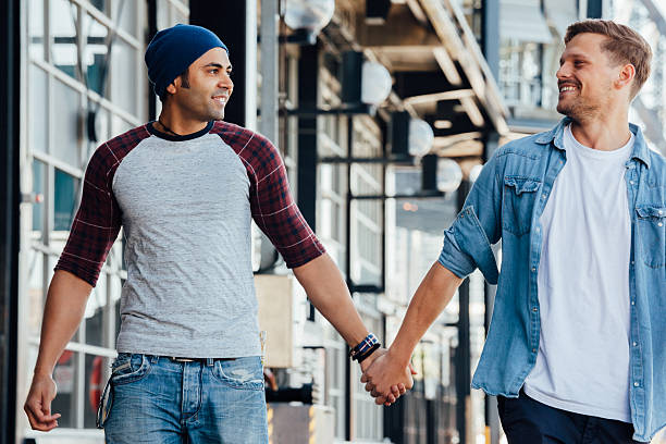 istock gay couple holding hands enjoying a walk 497125226