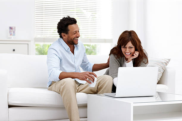 istock Cheerful mature couple using laptop at home 497126469