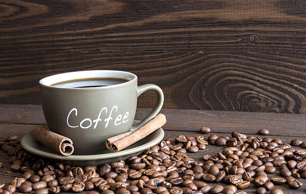 istock cup of coffee, coffee beans and cinnamon sticks bark 497126550
