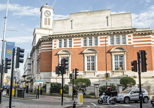 London, England - March 15, 2014:  Acton Town Hall in the centre of the West London suburb with traffic waiting at a junction.