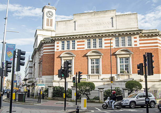 Acton Town Hall, West London London, England - March 15, 2014:  Acton Town Hall in the centre of the West London suburb with traffic waiting at a junction. eanling stock pictures, royalty-free photos & images