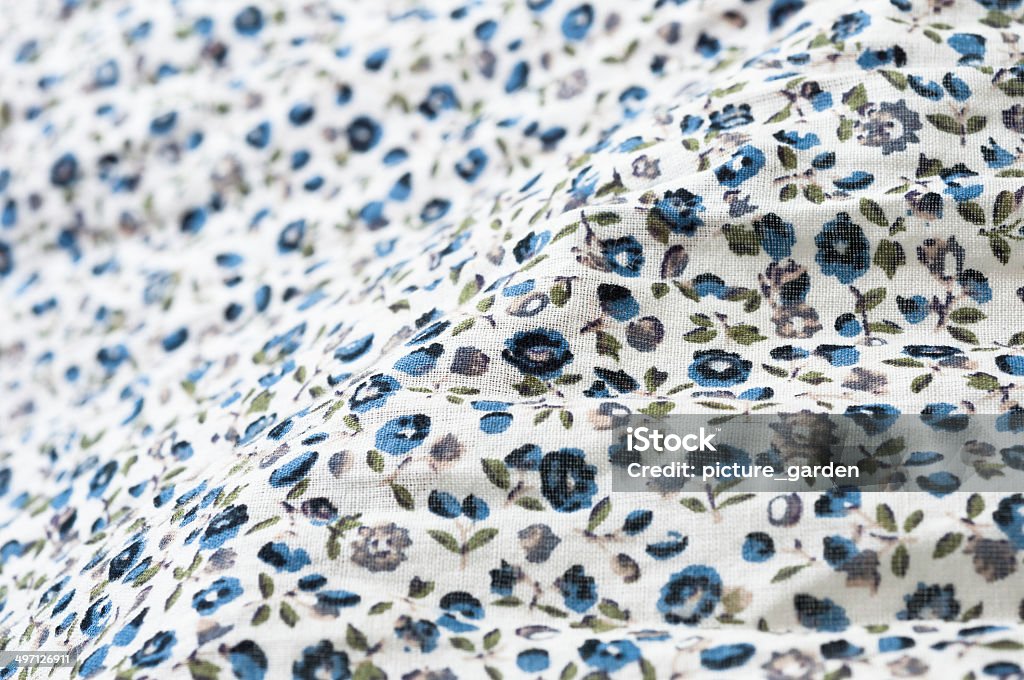 blurred detail of floral fabric close up of blue green floral pattern print on beige cotton cloth Beige Stock Photo