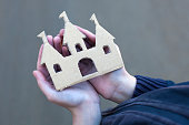 homeless boy holds a cardboard castle