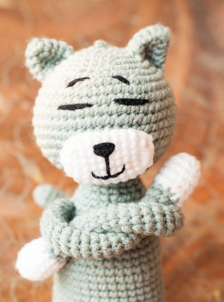 istock Knitted toy tabby cat isolated on white background 497127577