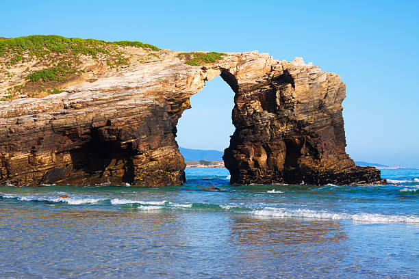istock Natural arch at beach in summer 497128284