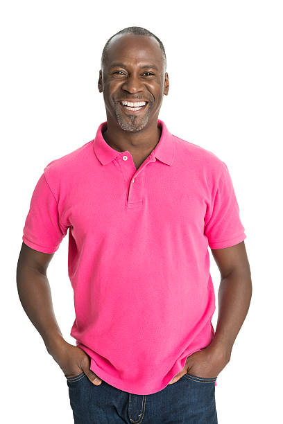 maduro hombre sonriente africano - vertical studio shot indoors pink fotografías e imágenes de stock