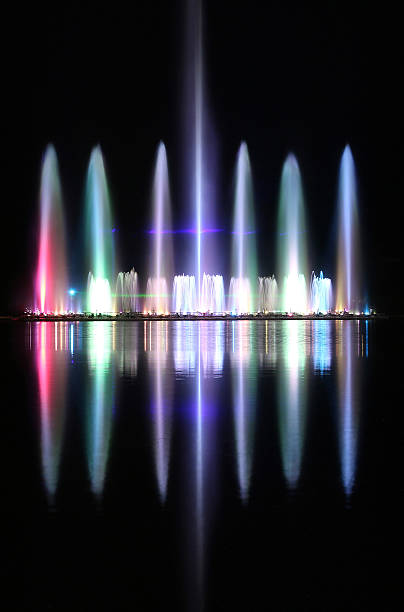 istock Dancing colorful fountain with reflection on water at night. 497130174