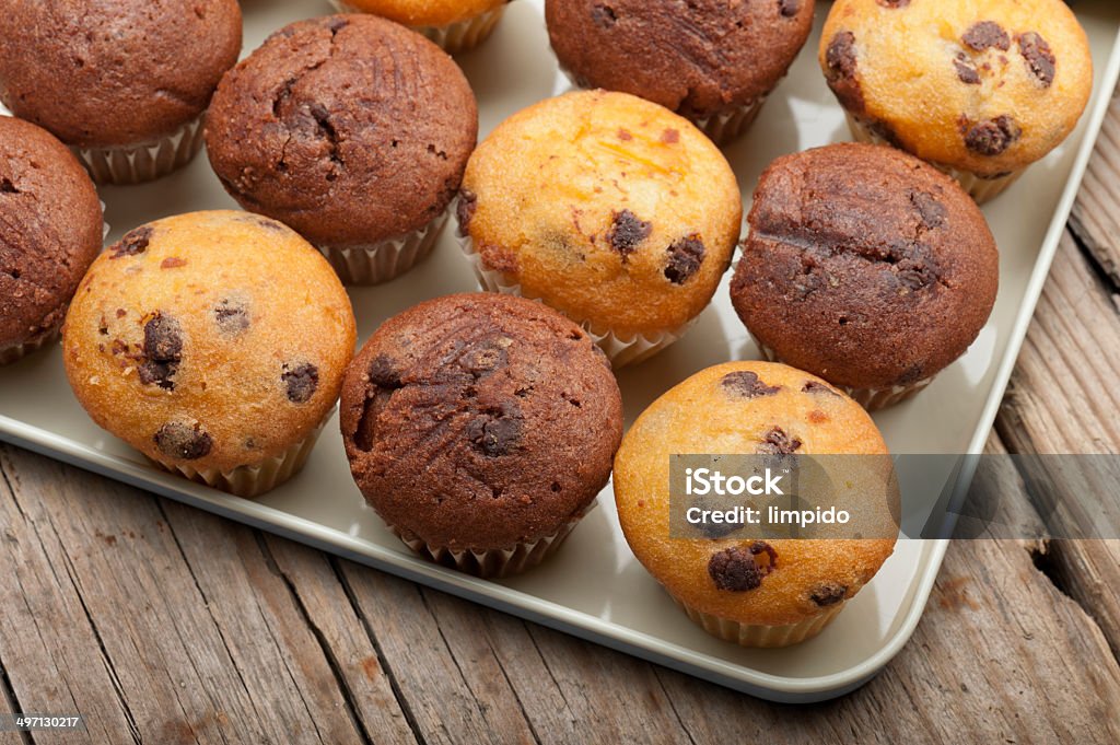 muffin tray of little muffins variety on wooden table Muffin Stock Photo