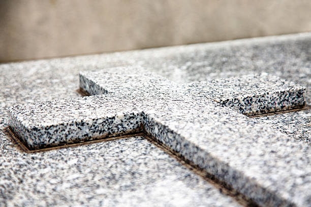 istock Marbled granite cross grave marker at cemetery 497130758