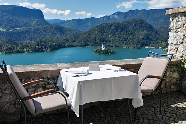 istock Served table with emty plate, lake Bled, island and Alps 497130902